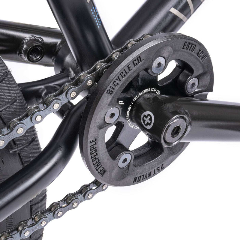 Close-up of the WETHEPEOPLE TRUST CS bike's paragon plastic guard sprocket and chain system.