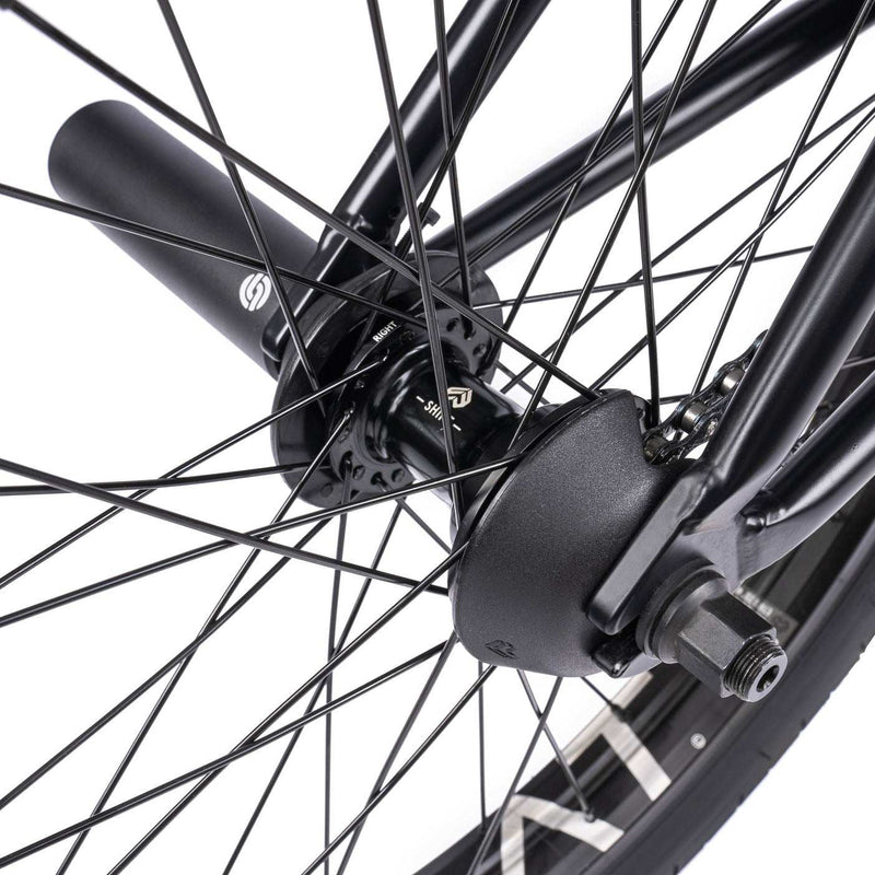 Close-up of rear wheel and hub guard on WETHEPEOPLE TRUST CS Complete Bike.