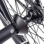 Close-up view of WETHEPEOPLE TRUST CS bike hub and pegs showcasing high-quality components.