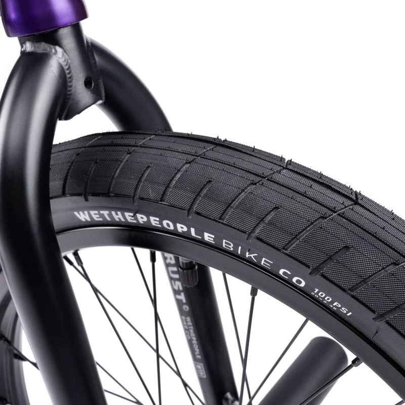 WETHEPEOPLE TRUST CS BMX bike close-up, showcasing "Activate" tire and "Trust" frame detailing.