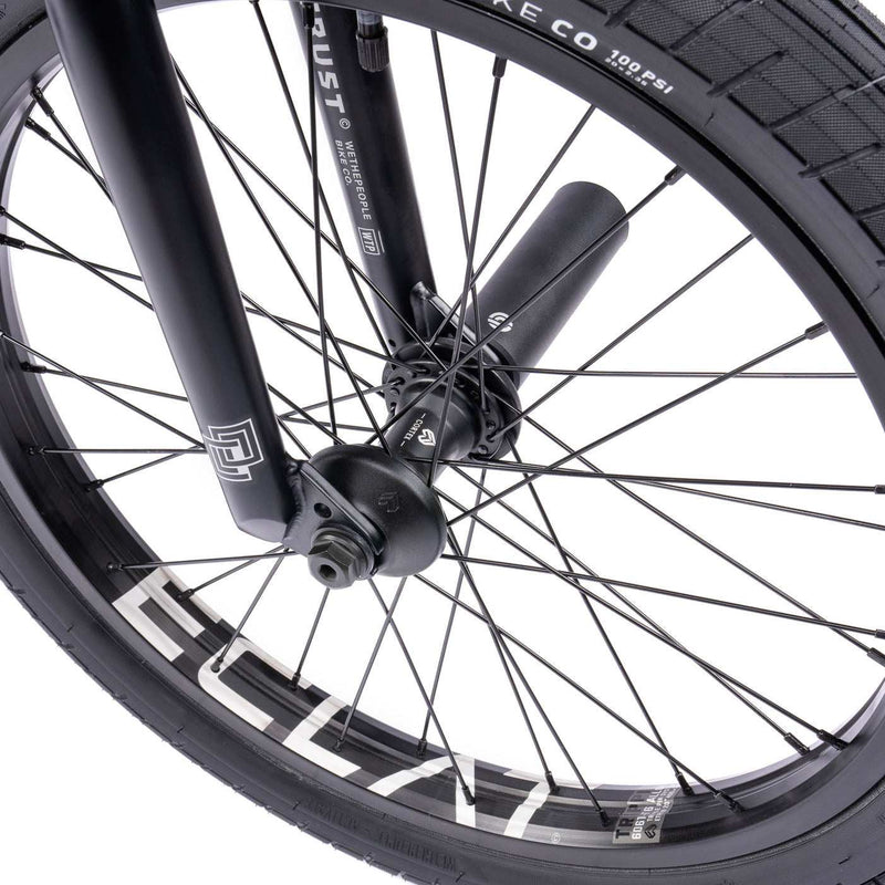 Close-up of WETHEPEOPLE TRUST CS bike wheel featuring éclat hub and activate tire.
