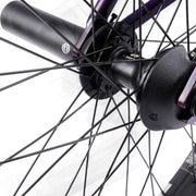 Close-up view of the WETHEPEOPLE TRUST CS bike's rear hub and spokes featuring the éclat "cortex" cassette hub and nylon/fiberglass hub guard.