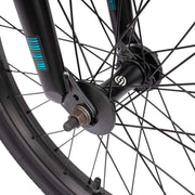 Close-up of the front wheel hub and spokes on the Wethepeople Justice Bike with black fork and tire details