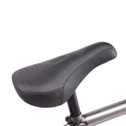 Close-up of black sleek pivotal seat on WETHEPEOPLE JUSTICE BIKE with tubular frame background