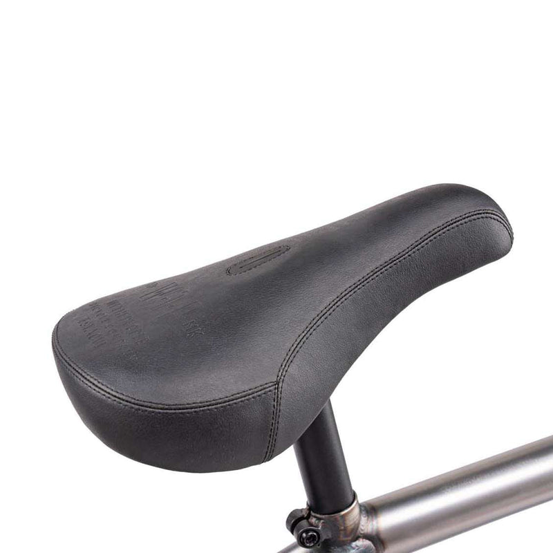 Close-up of black sleek pivotal seat on WETHEPEOPLE JUSTICE BIKE with tubular frame background