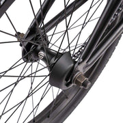 Close-up of Wethepeople Justice Bike black rear wheel hub and spokes with hub guard protection