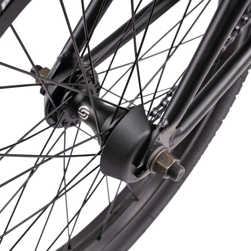 Close-up of Wethepeople Justice Bike black rear wheel hub and spokes with hub guard protection