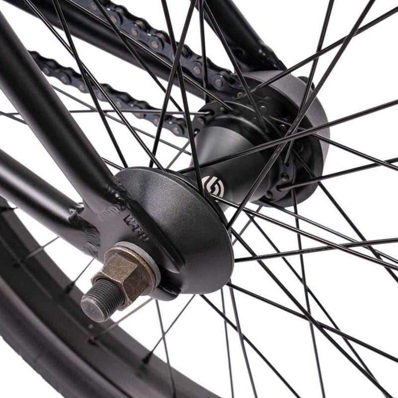 Close-up of Wethepeople Justice Bike rear wheel hub with black spokes and chain